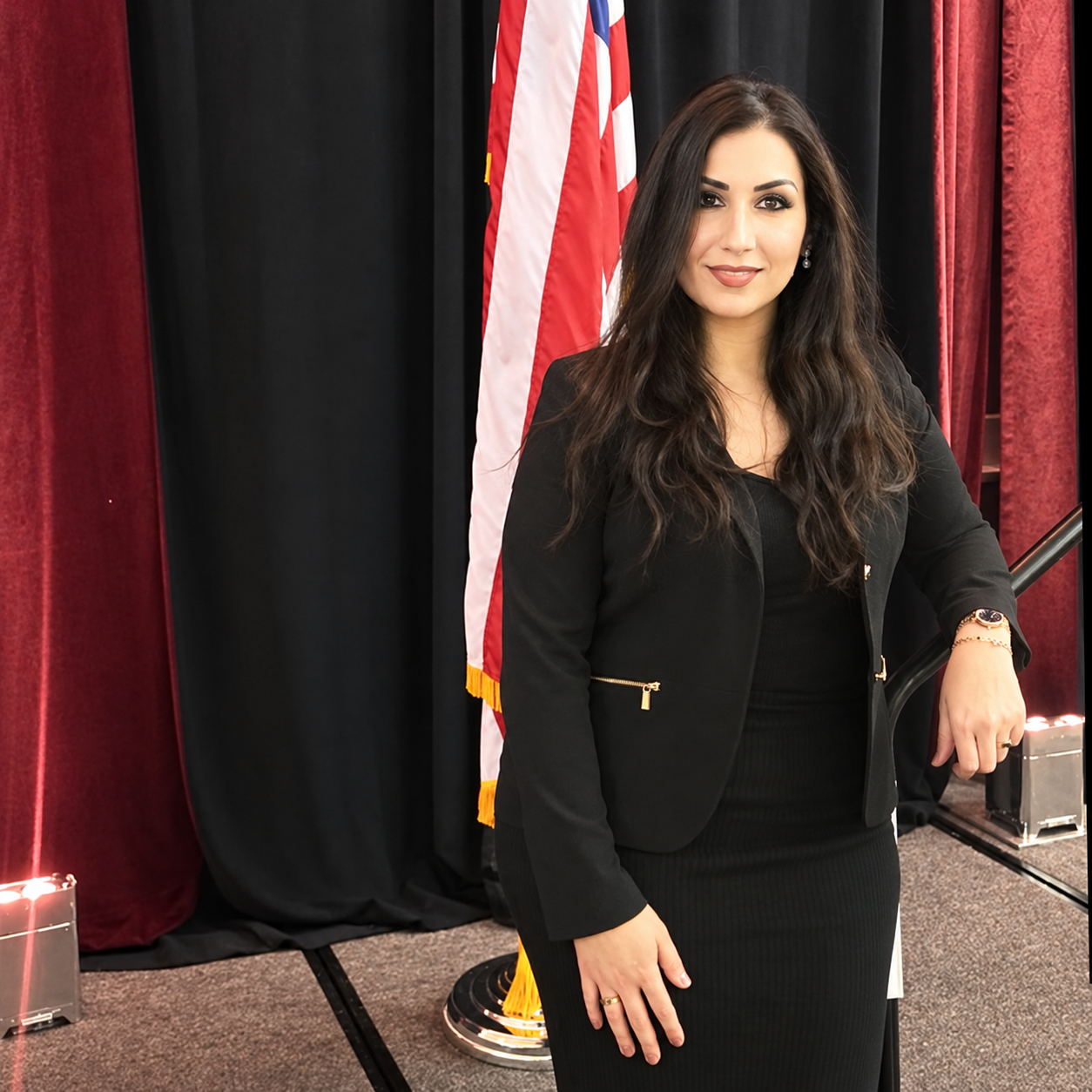 Hanan Haddad Thwany beside the American flag